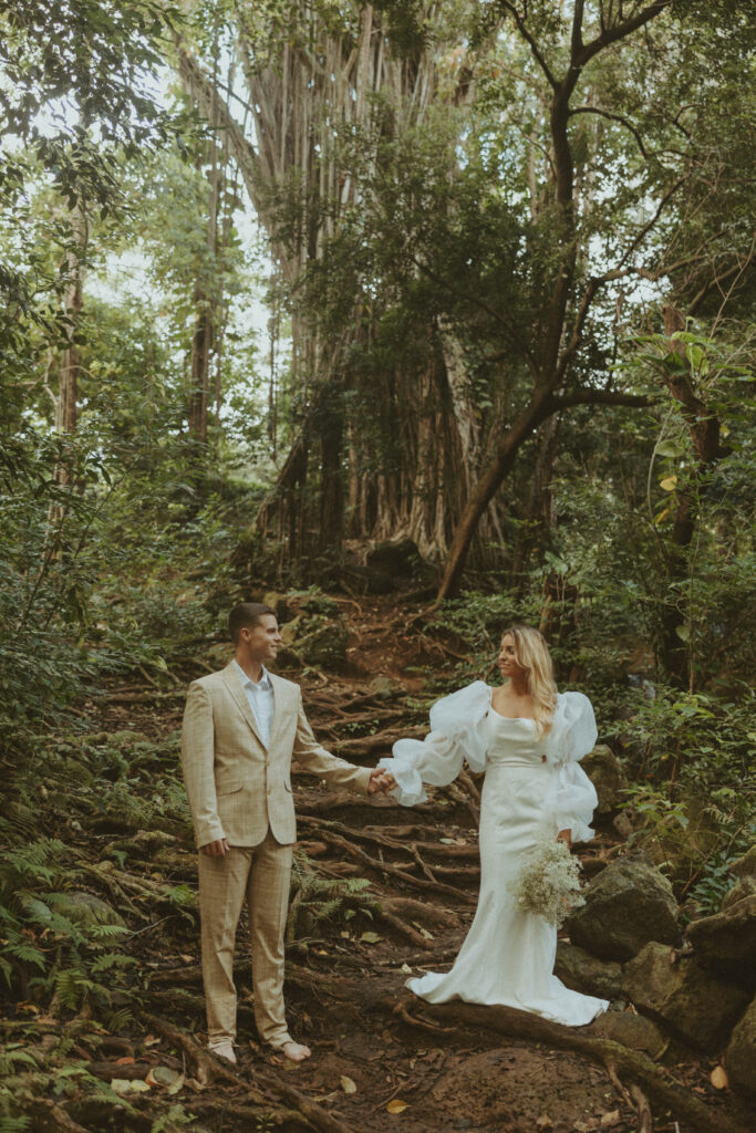 couple posing for their elopement pictures in the jungle of hawaii