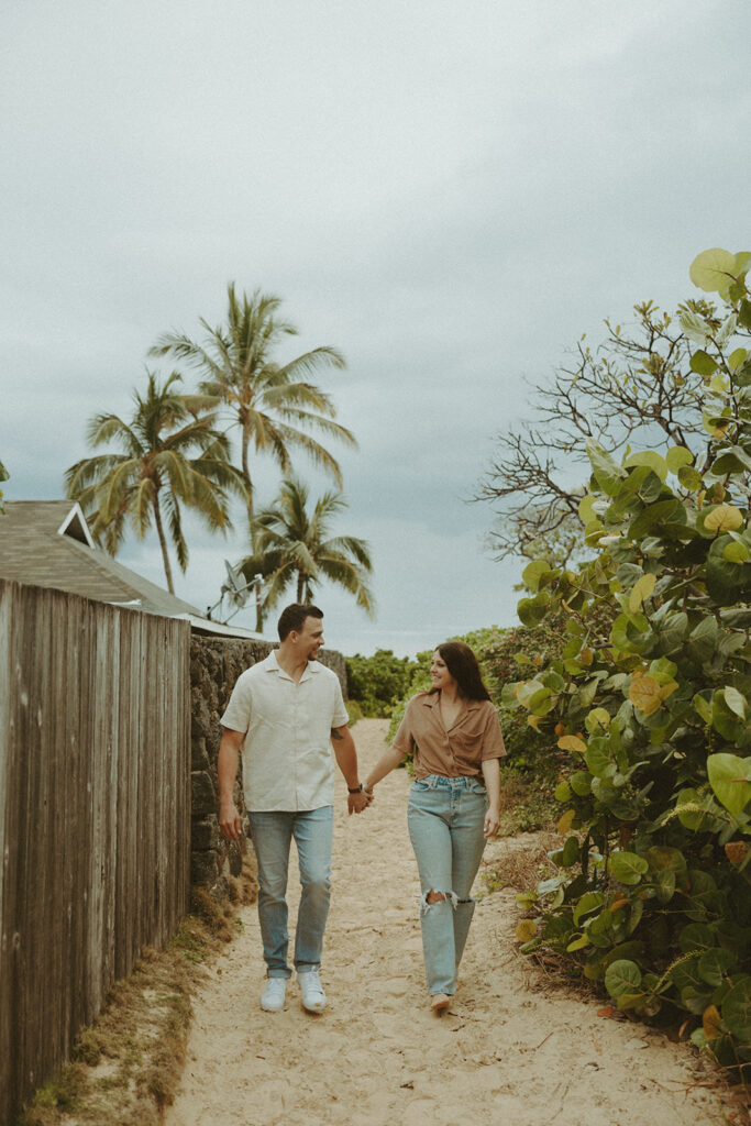 couple posing for their photo in hawaii on the beach