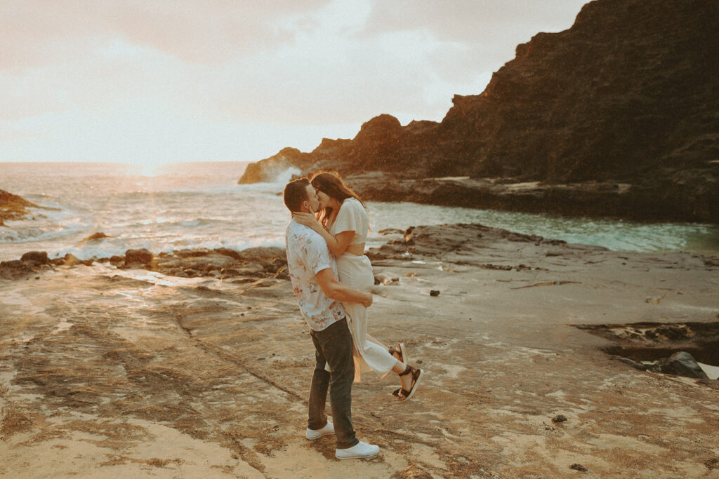 couple posing for their photo in hawaii on the beach