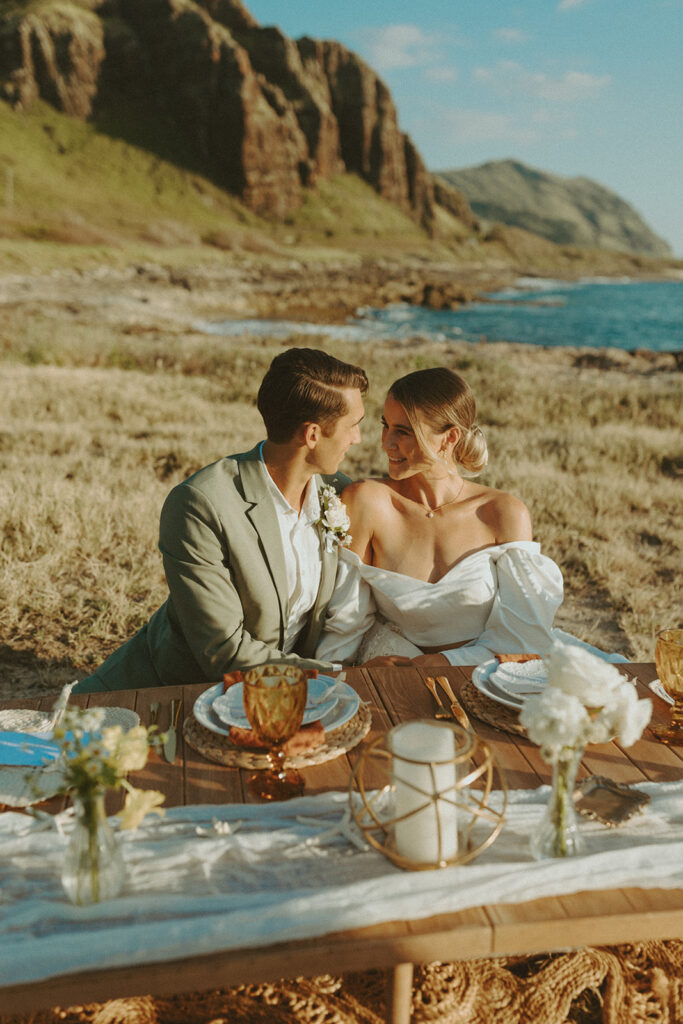 couple on the beach in hawaii posing for their elopement photos