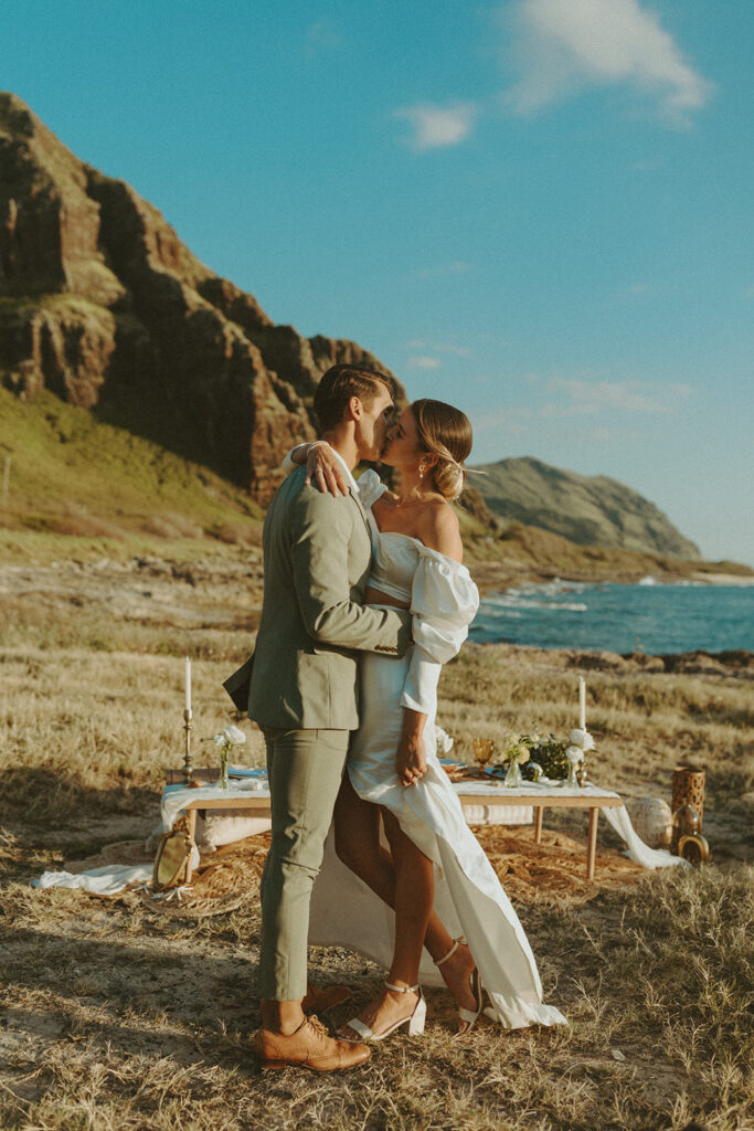 couple on the beach in hawaii posing for their elopement photos
