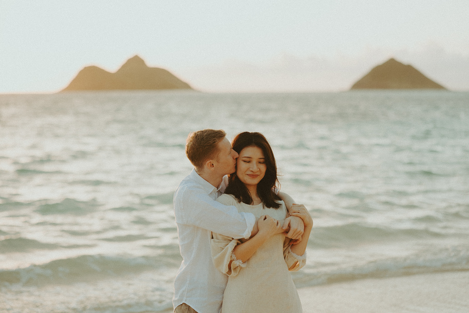Couple posing for their photos on the beach in oahu