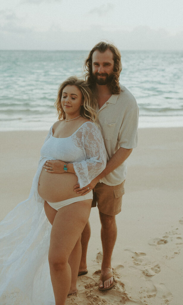 couple posing for their maternity photos on a beach in oahu - beach maternity session
