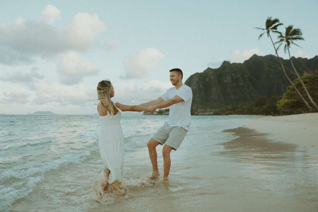 a couple posing for their engagement photos in oahu at kualoa ranch