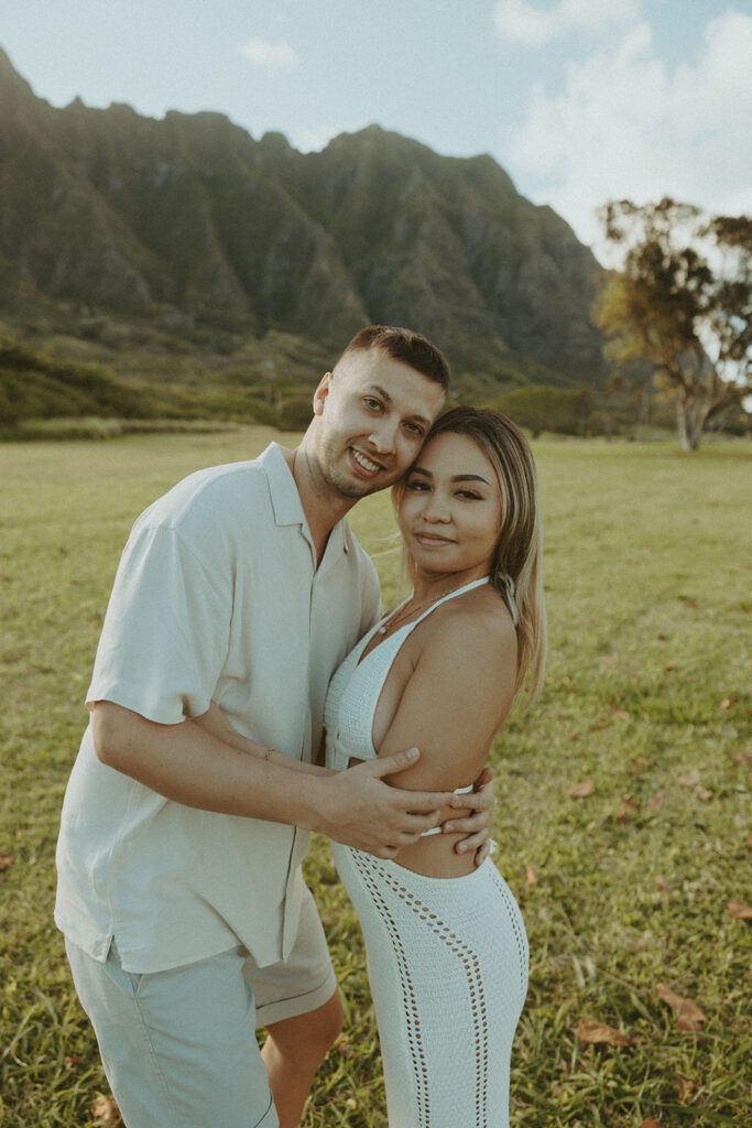 a playful couple posing in hawaii for their engagement photos
