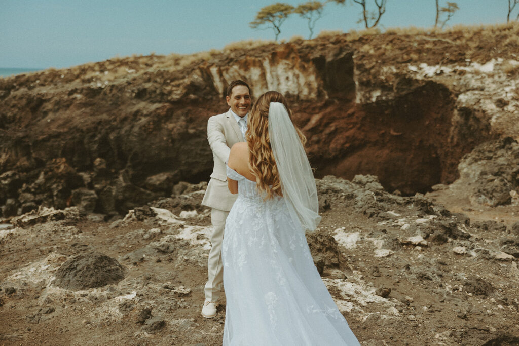 bride and groom posing on the beach for their destination wedding photos | A Peaceful and Laid Back Big Island Hawaii Wedding
