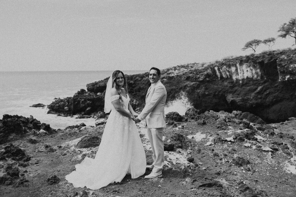 bride and groom in hawaii for their destination wedding having a picnic