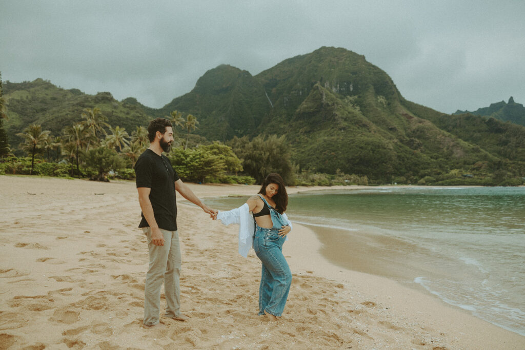 boho maternity session - a couples posing on a beach in kauai for their maternity photoshoot
