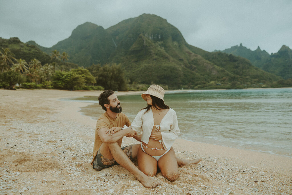 couple posing on kauai for their maternity photos - boho maternity session
