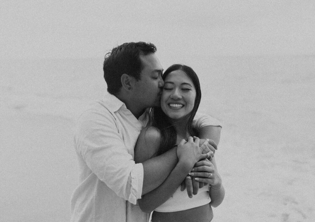 couple taking their honeymoon photoshoot on the beach in hawaii