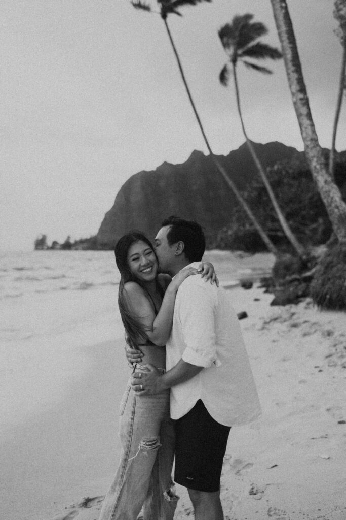 couple posing on the beach in hawaii - honeymoon pictures