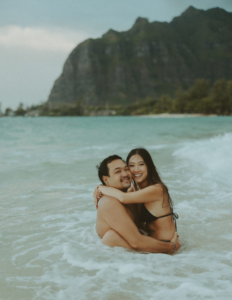 couple posing on the beach in hawaii - honeymoon pictures
