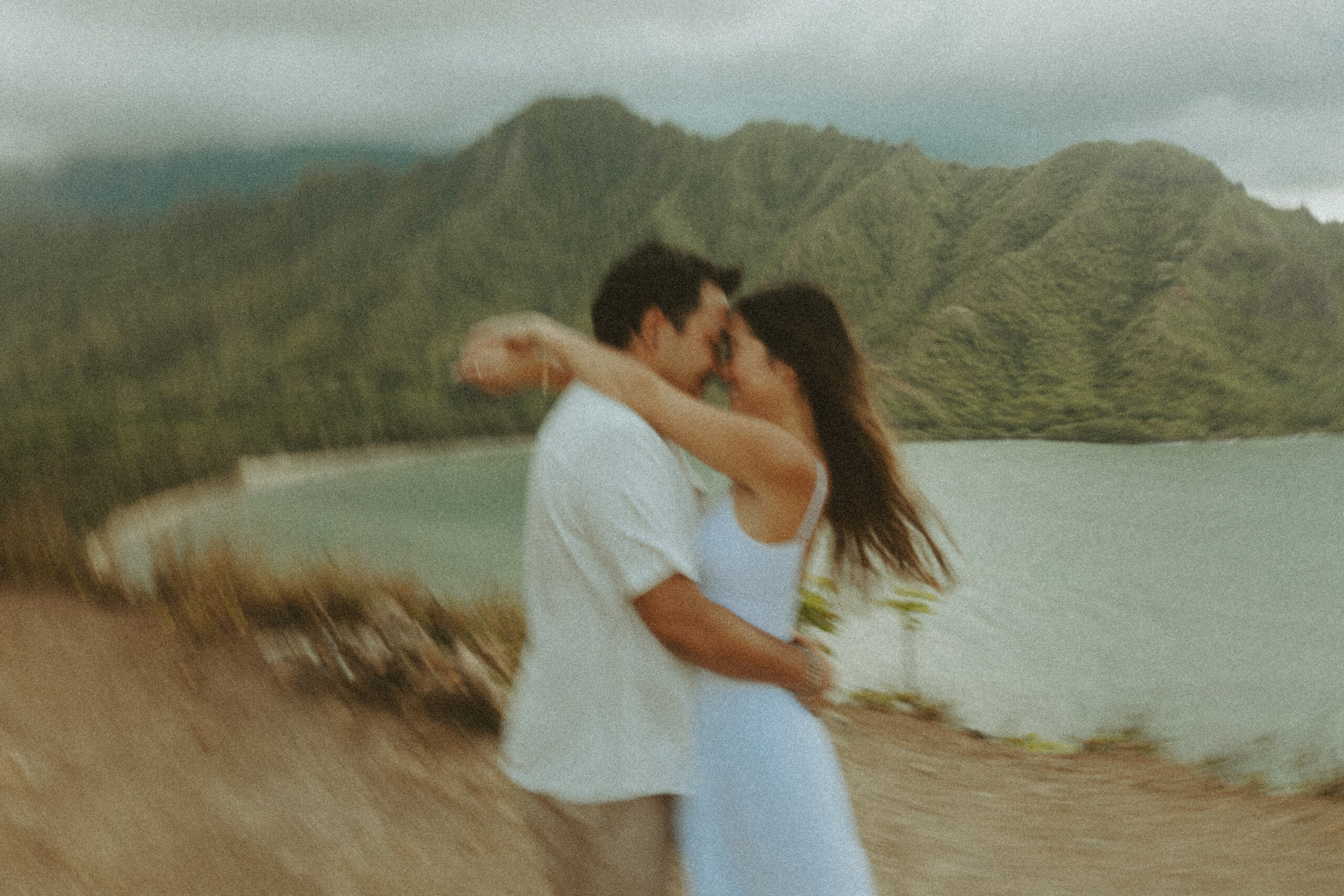 couple posing on the beach in hawaii - honeymoon pictures