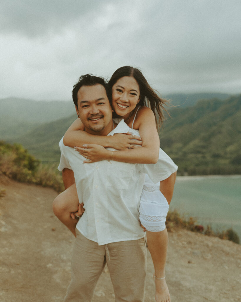 couple taking their honeymoon photoshoot on the beach in hawaii
