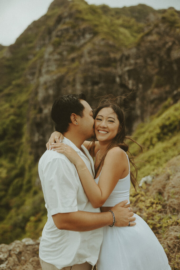 couple taking their honeymoon photoshoot on the beach in hawaii