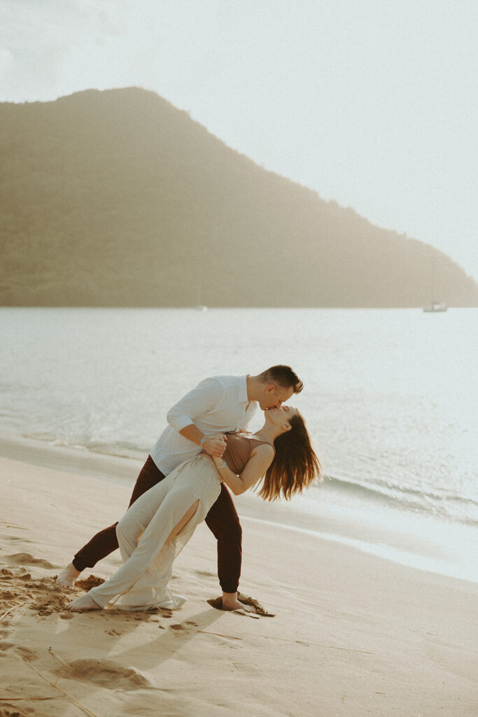 couple posing on the beach in st lucia for their day before wedding photos