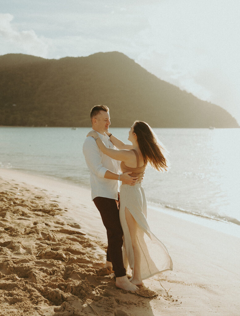 couple posing on the beach in st lucia for their day before wedding photos