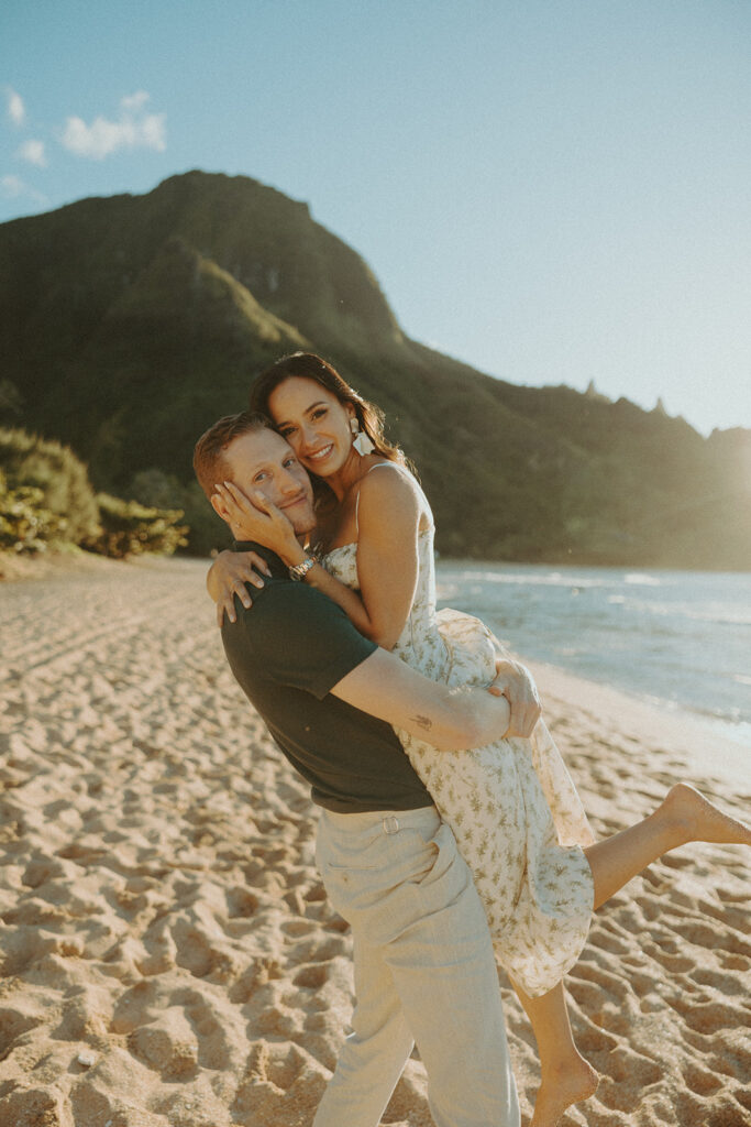 couple on the beach having an engagement photoshoot