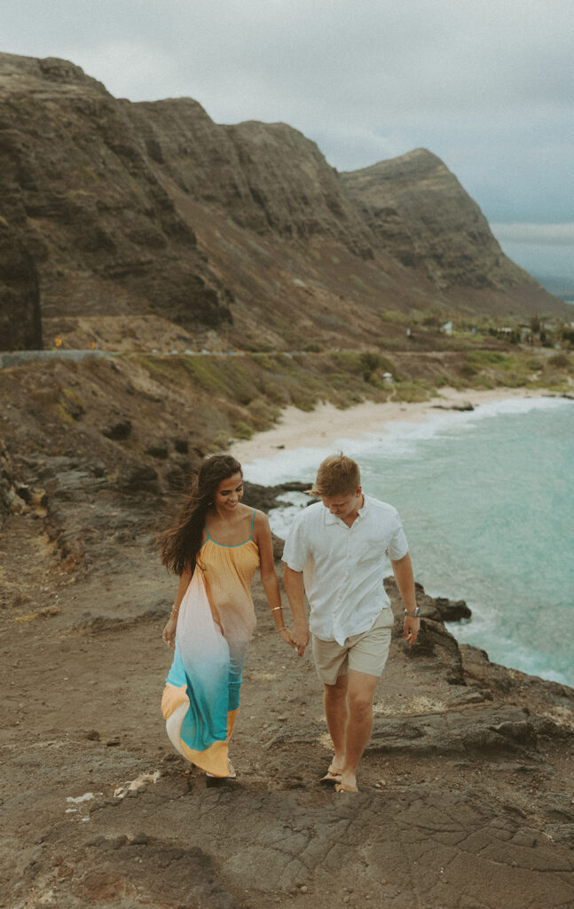 couple posing on the beach for a honeymoon photoshoot
