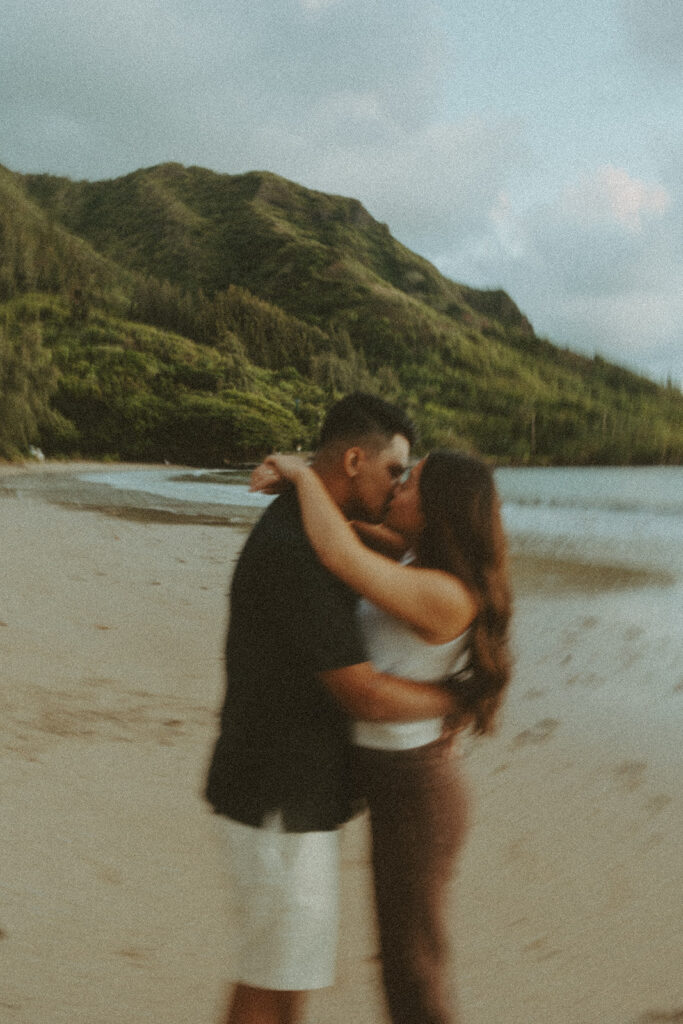 A Playful Sunrise Honeymoon Photoshoot in Hawaii | A couple posing on the beaches of hawaii for a honeymoon photoshoot
