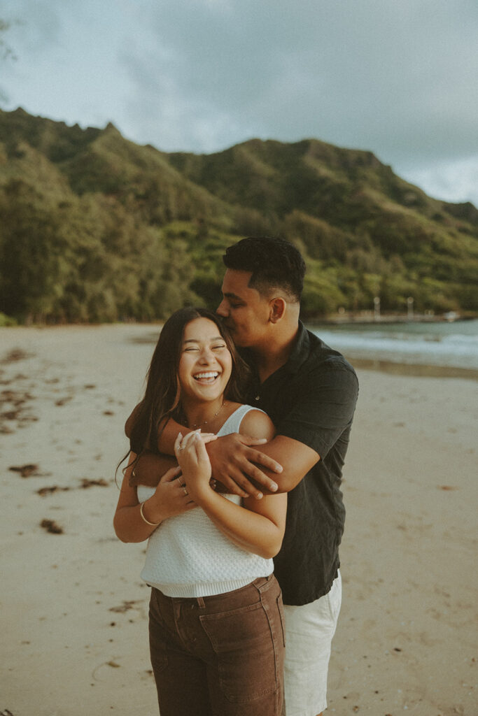 couple playing on the beaches of hawaii for a photoshoot session
