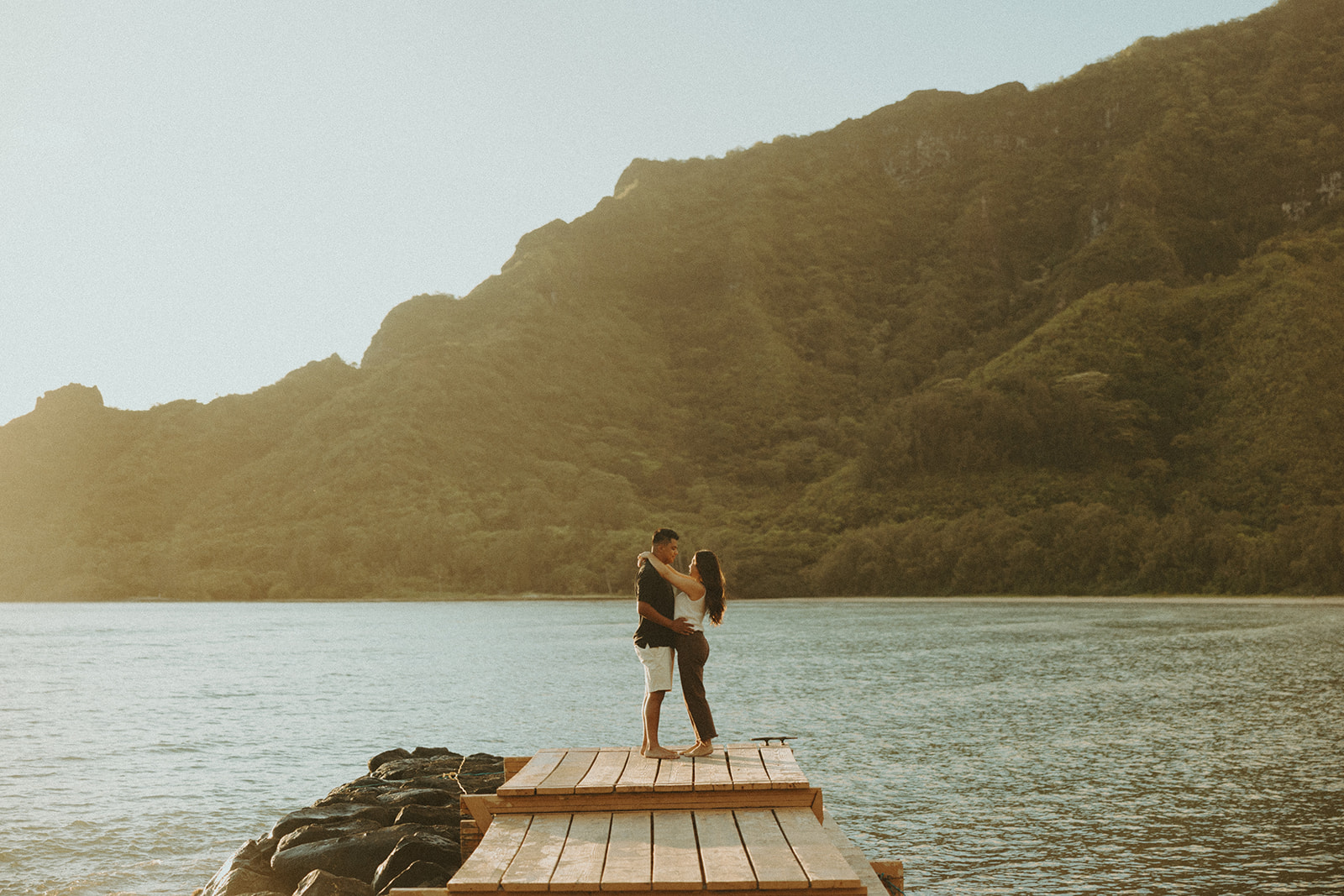 A couple posing on the beaches of hawaii for a honeymoon photoshoot