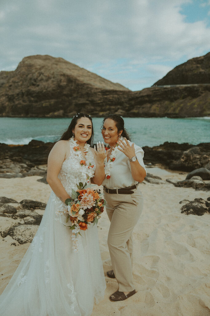 an elopement photoshoot in hawaii with couple posing on the beach
