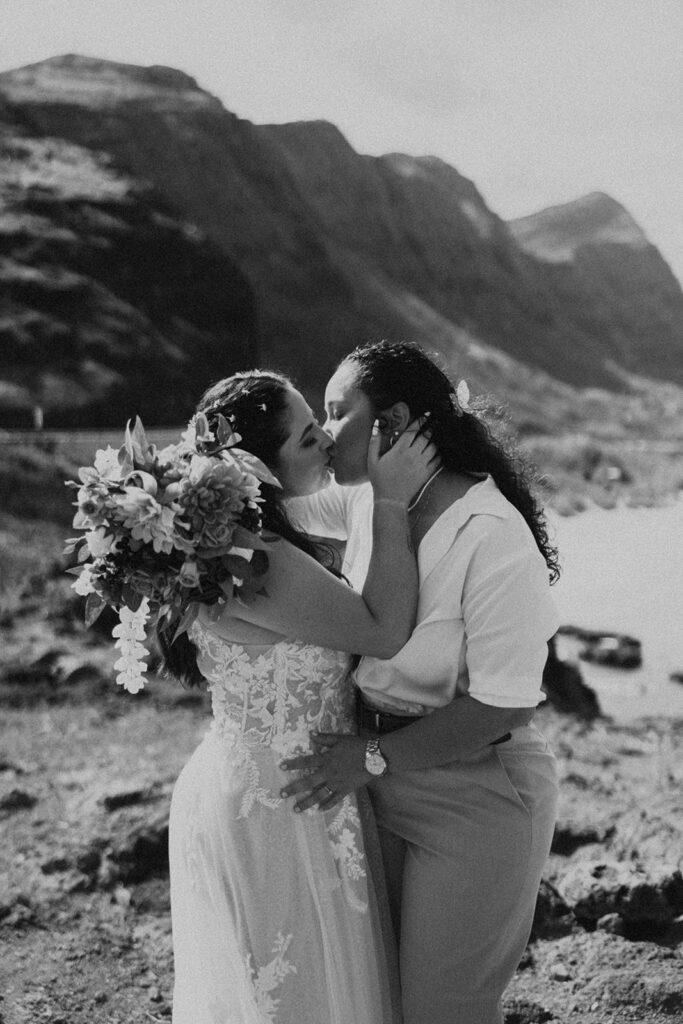 an elopement photoshoot in hawaii with couple posing on the beach
