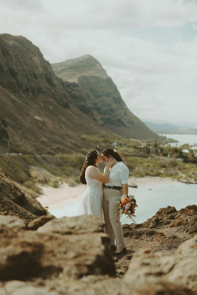Couple posing on the beach in oahu for their wedding elopement
