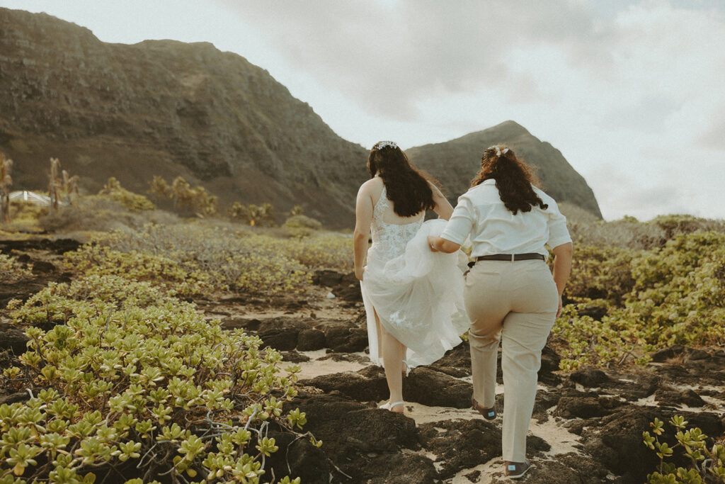 Couple posing on the beach in oahu for their wedding elopement
