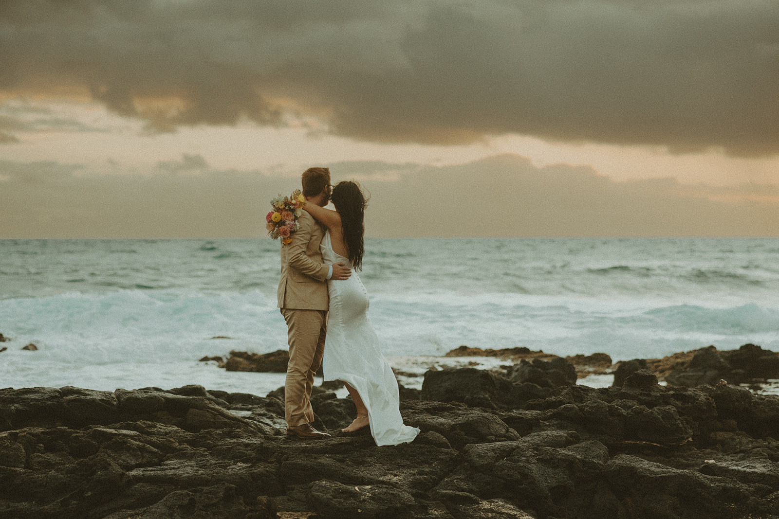 Couple posing for wedding photos in oahu