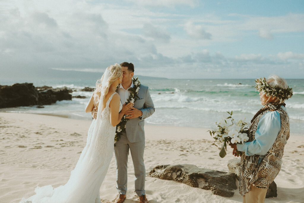 couple having a beachside elopement in hawaii

