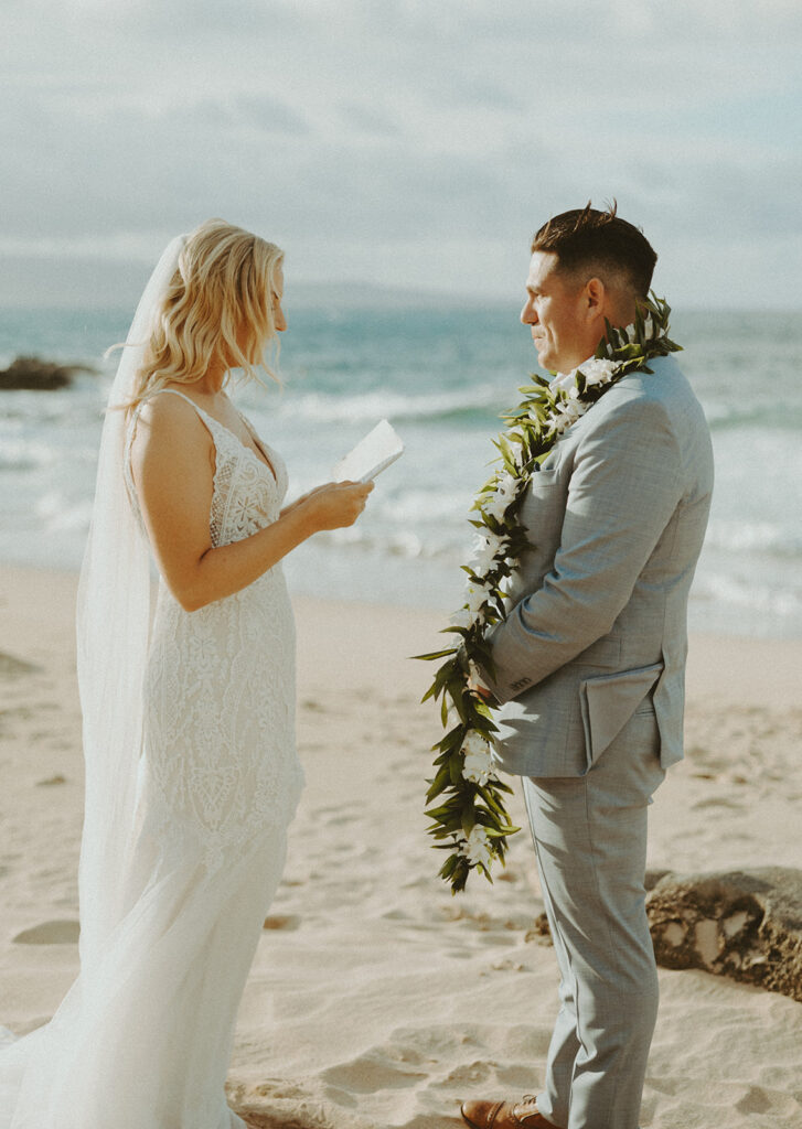 couple having a beachside elopement in hawaii
