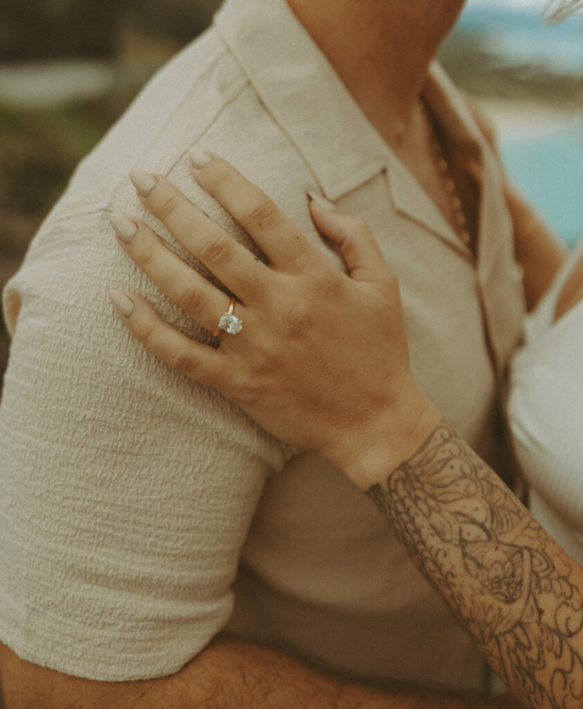 couples posing for their engagement photos in hawaii
