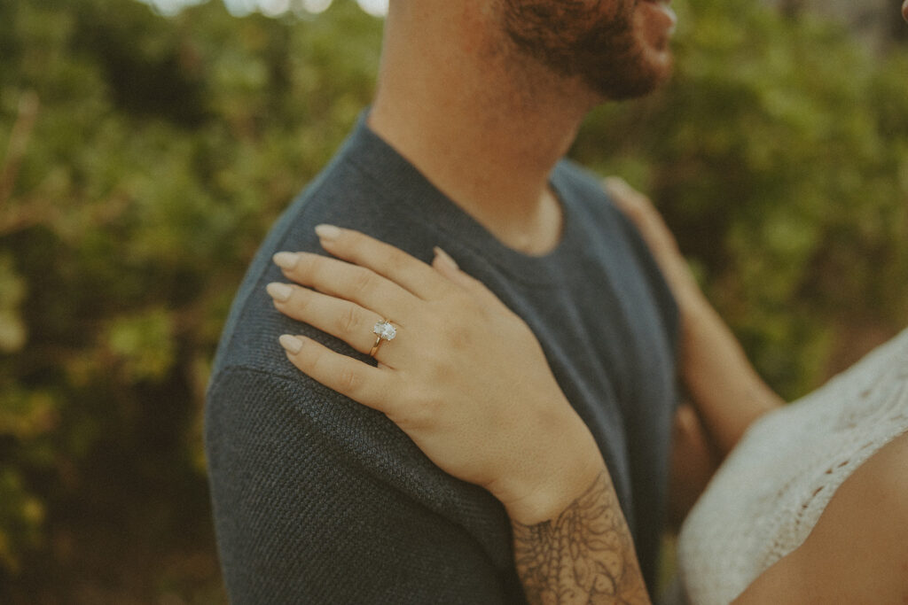 a couple taking engagement photos on a beach