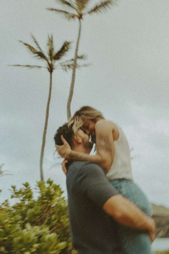 couples posing for their engagement photos in hawaii
