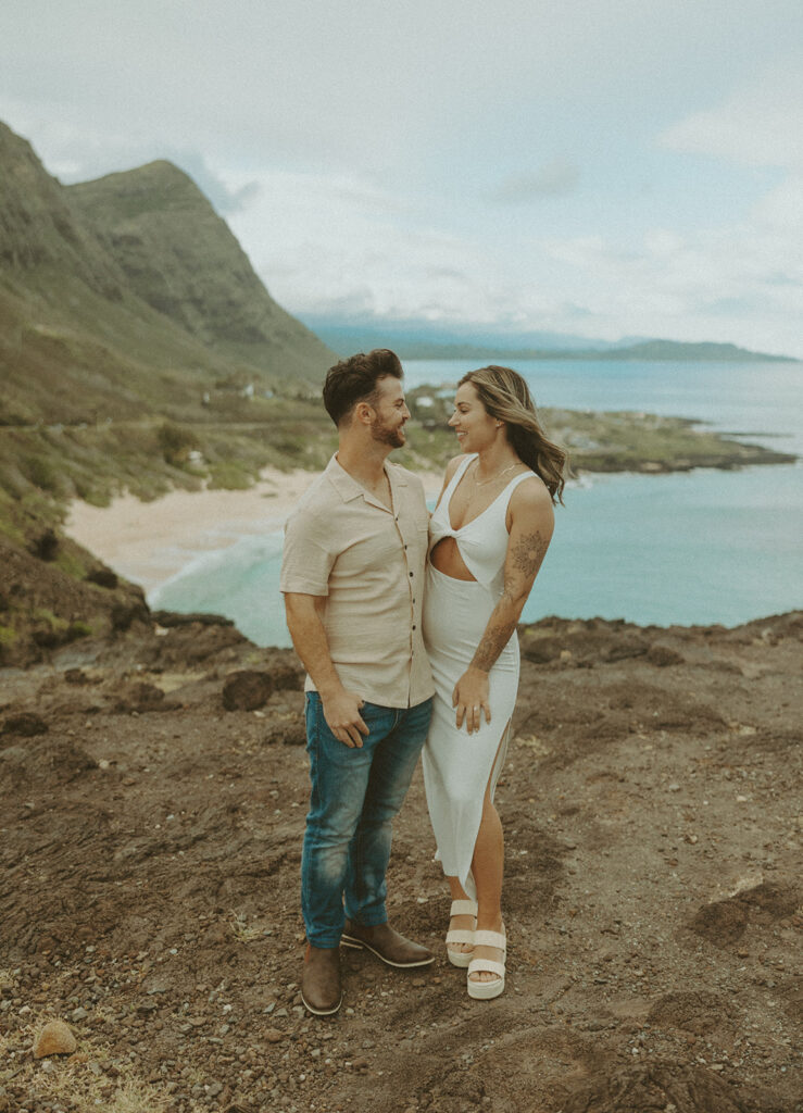 couples posing for their engagement photos in hawaii
