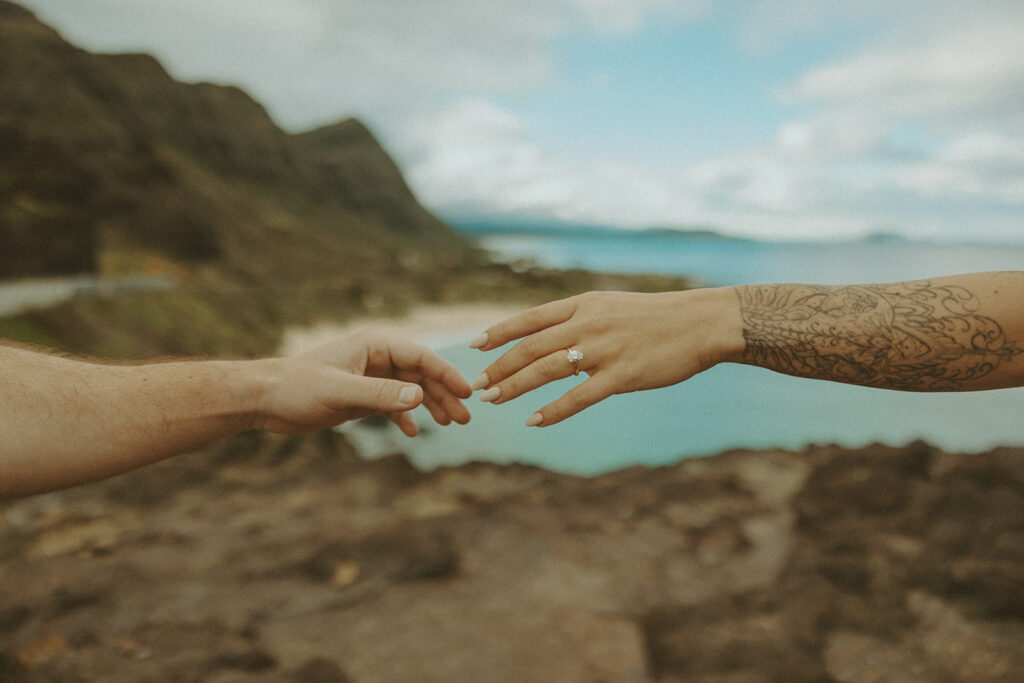 a couple taking engagement photos on a beach
