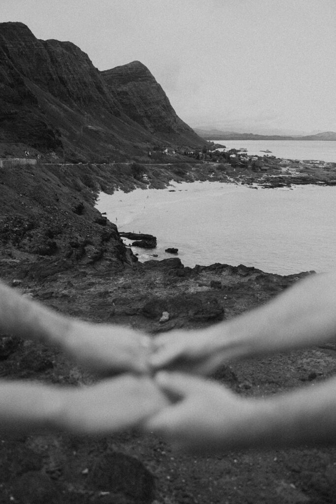 a couple taking engagement photos on a beach
