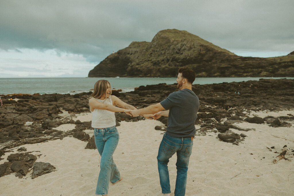 couples posing for their engagement photos in hawaii
