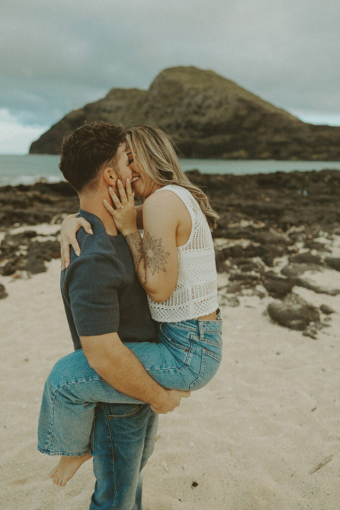 couples posing for their engagement photos in hawaii
