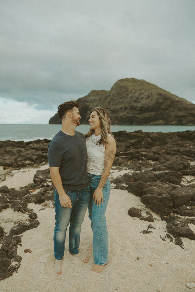 couples posing for their engagement photos in hawaii
