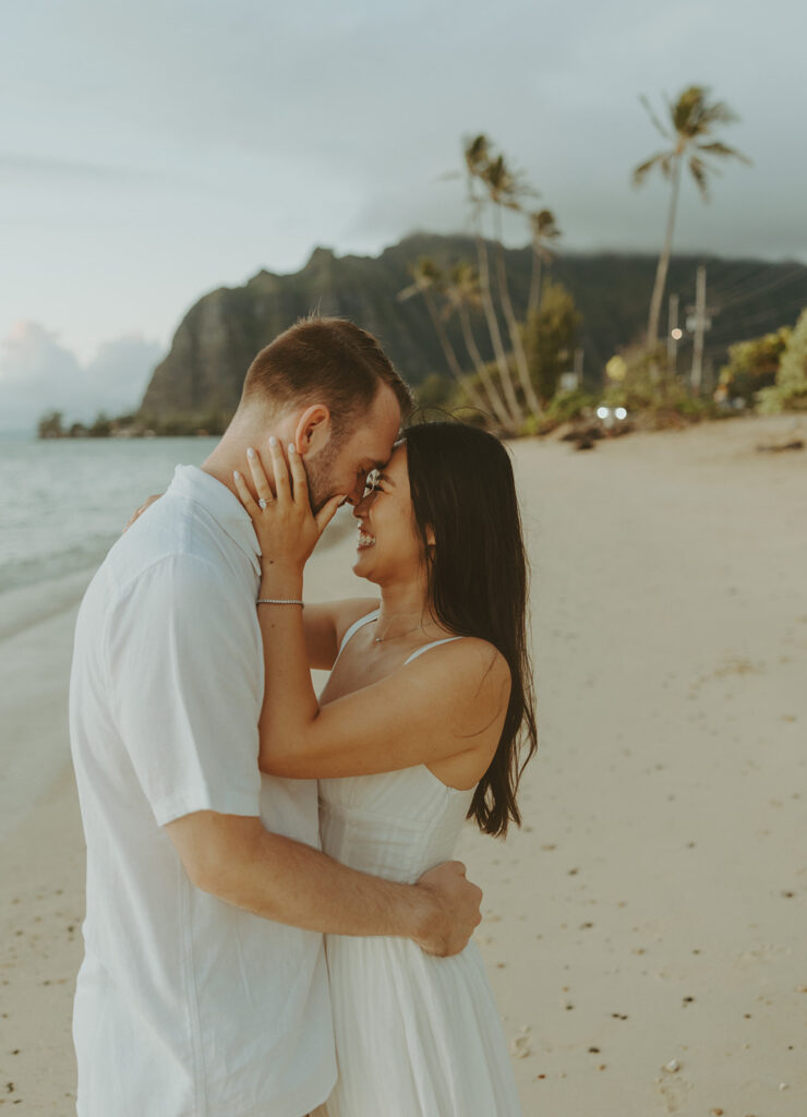 a couple posing for their engagement photos in hawaii
