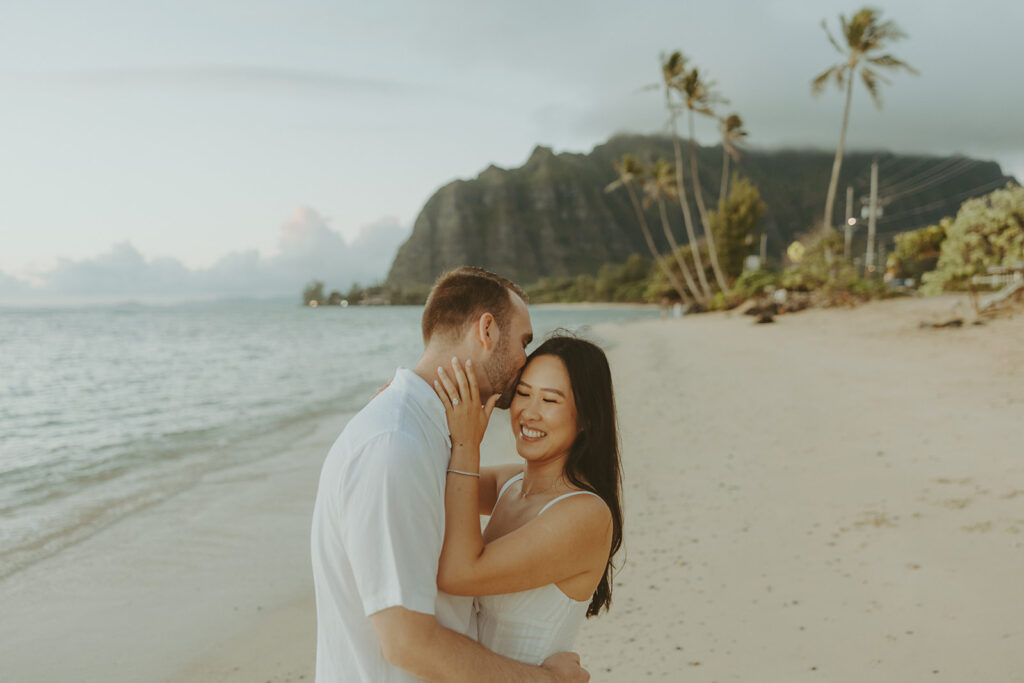 a couple posing for their engagement photos in hawaii