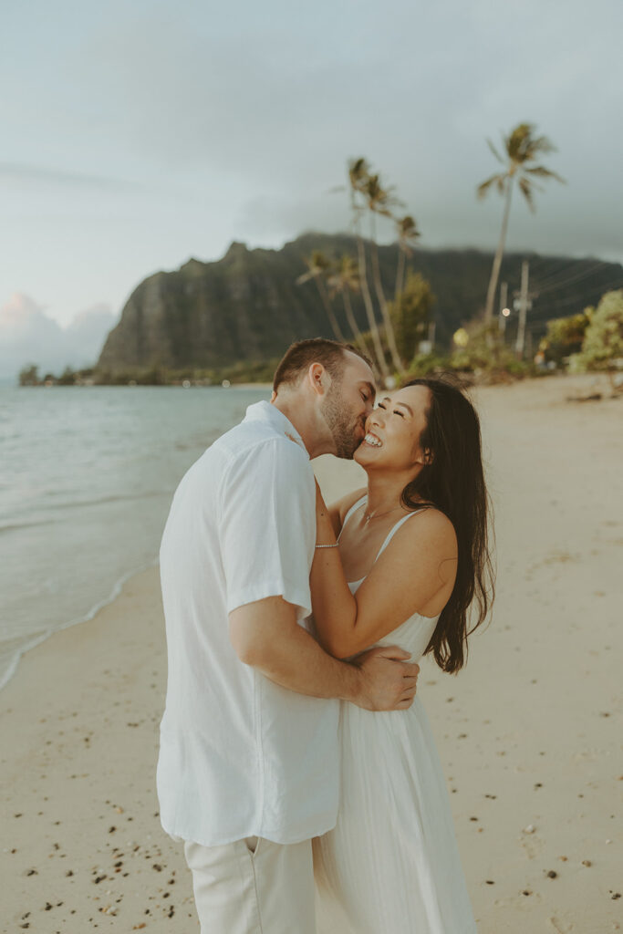 a couple posing for their engagement photos in hawaii
