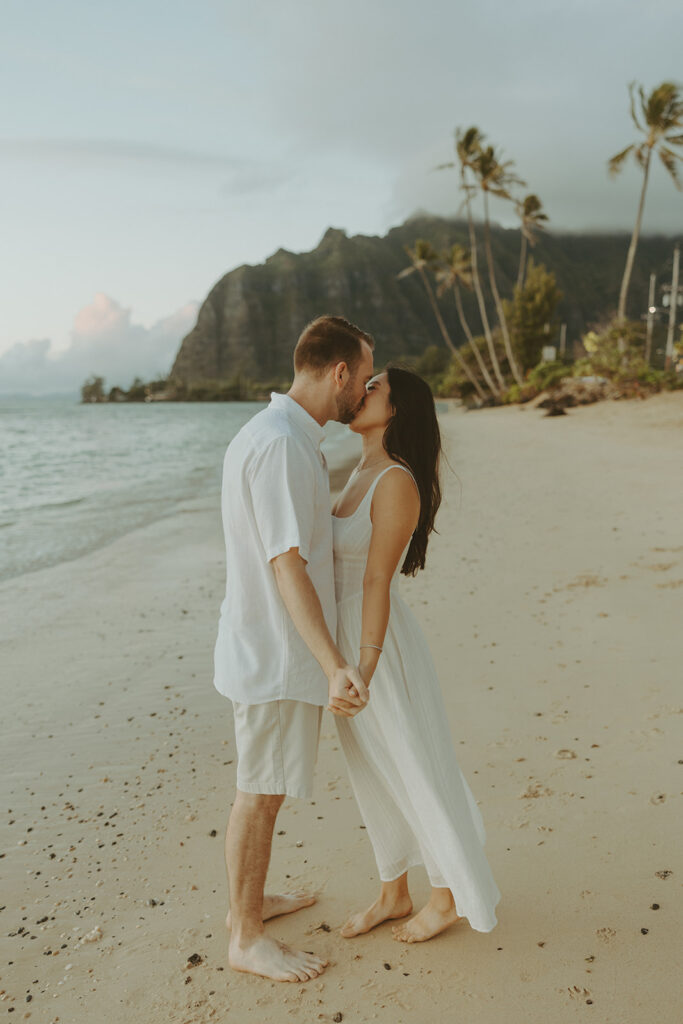 a couple posing for their engagement photos in hawaii