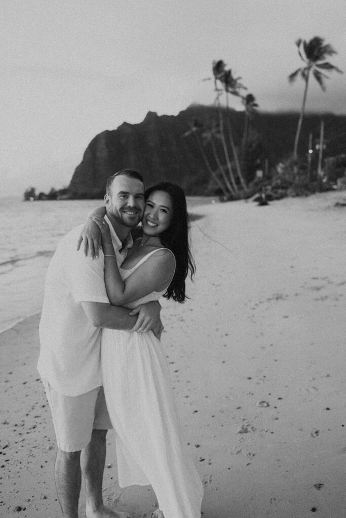 a couple posing for their engagement photos in hawaii
