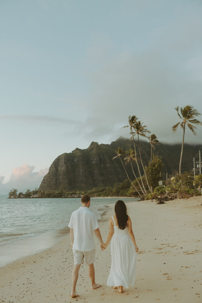 a couple posing for their engagement photos in hawaii
