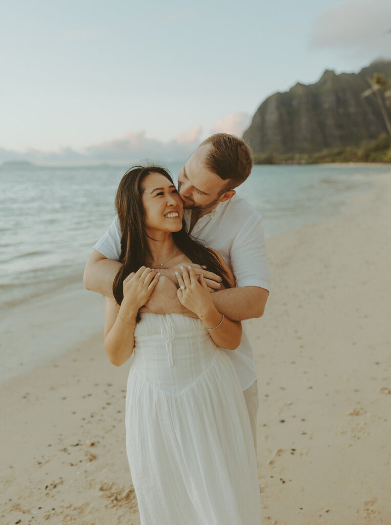 a couple posing for their engagement photos in hawaii
