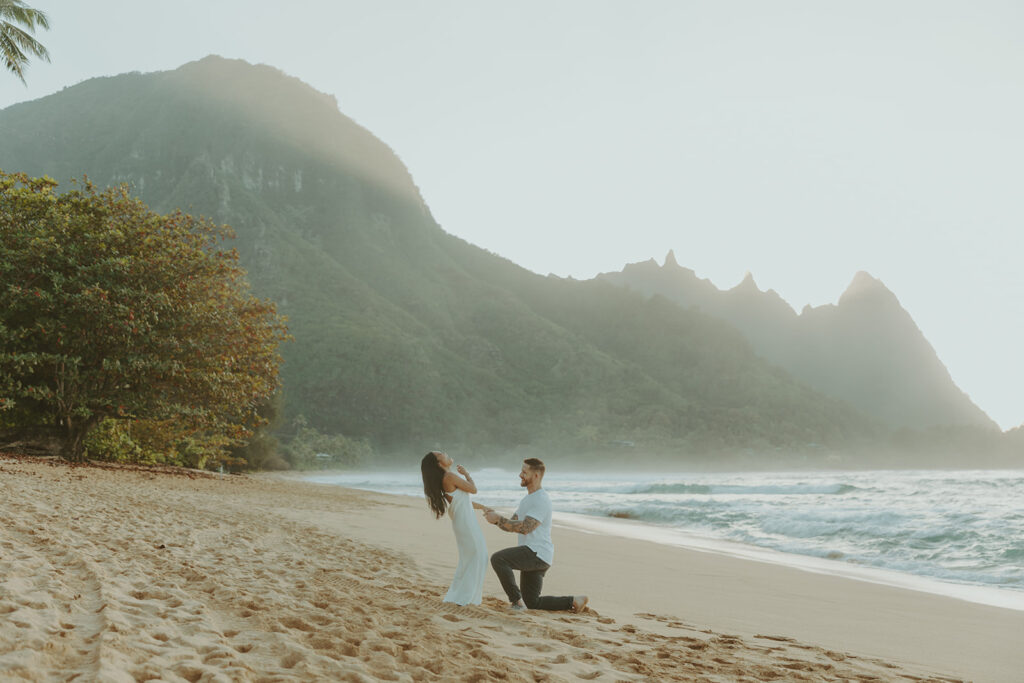 Man proposing to his girlfriend on the beach in Kauai
